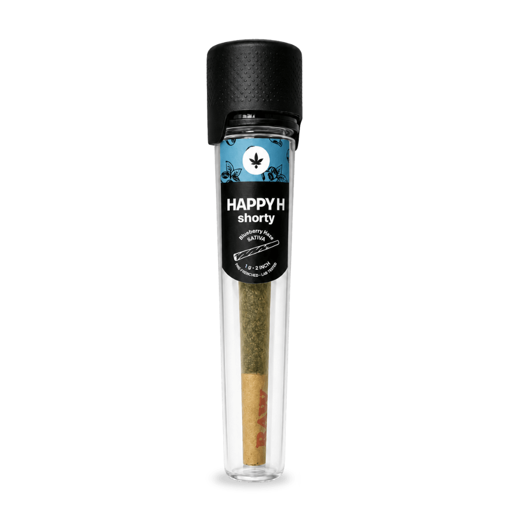 Egy „Happy H Shorty – Pineapple Express | CBDX-vel dúsított előre sodort cigaretta, 1 g” feliratú, előre sodort cigaretta, amely egy fekete kupakos, átlátszó műanyag csőben található. A címkén kék mintázat, egy kannabiszlevél-szimbólum és a „SATIVA” felirat látható. A cigaretta végén a „RAW” felirat szerepel.
