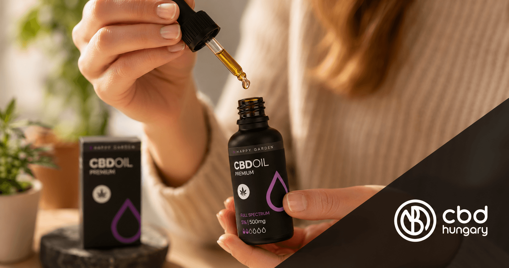 Egy személy egy cseppentőt tart egy CBD-olajos üveg felett; az előtérben egy „CBD Oil Premium” feliratú doboz és a CBD Europe logó látható.
